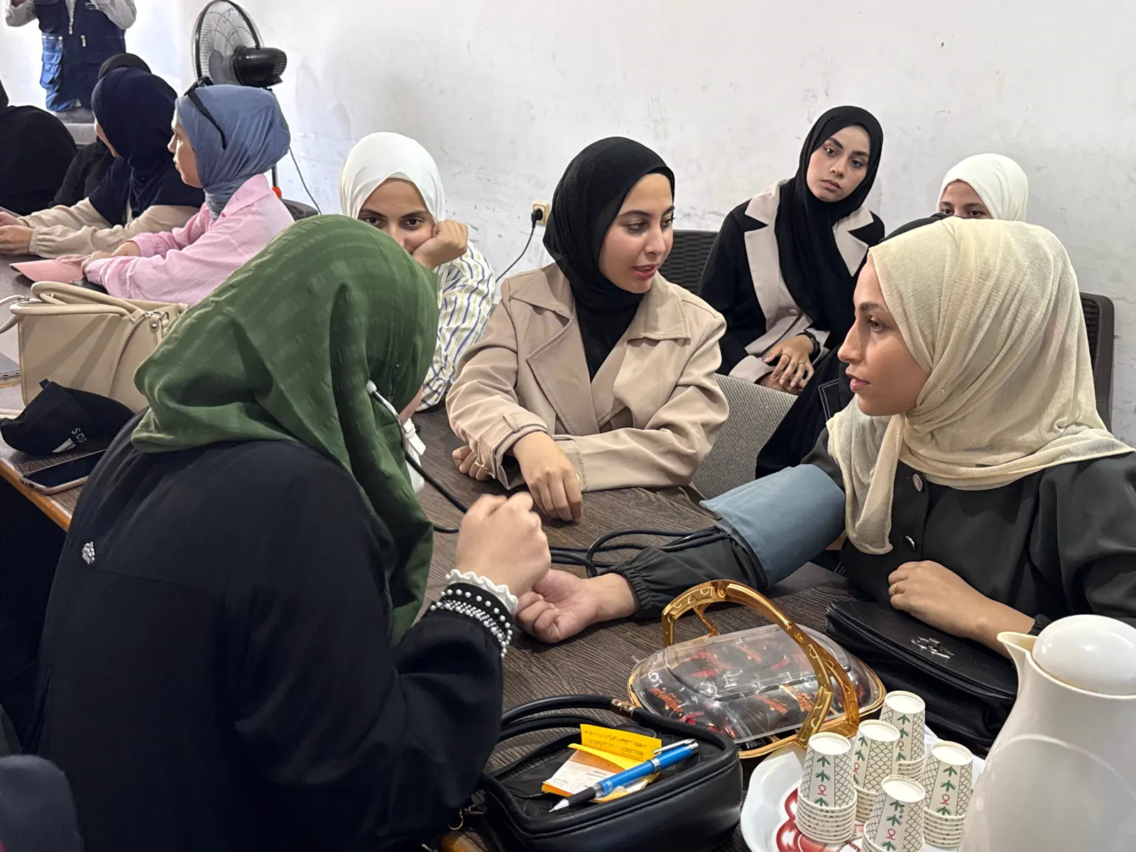 Students practising blood pressure measurement in pairs
