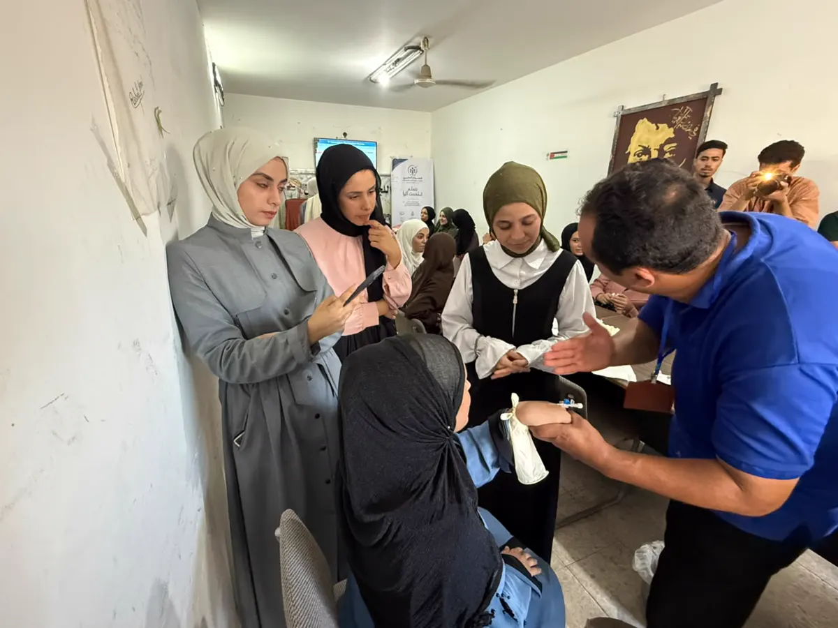Students practising bandaging with a trainer
