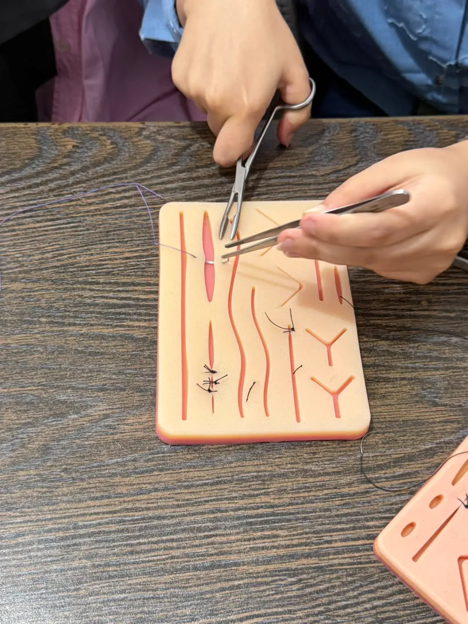 Stitches on a suture practice pad