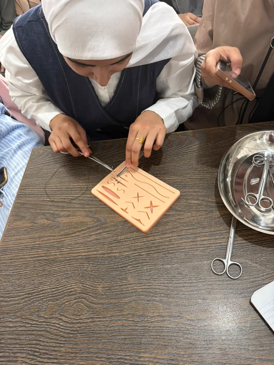 A student practising suturing on a pad