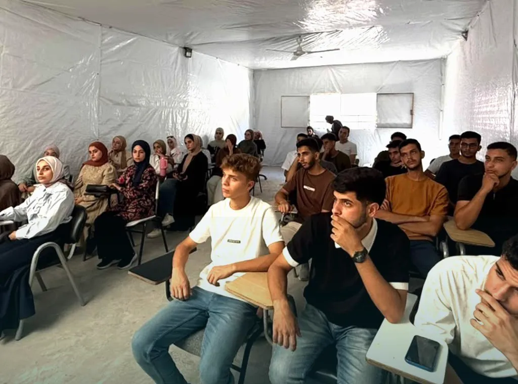 Students seated and listening closely during the suturing course